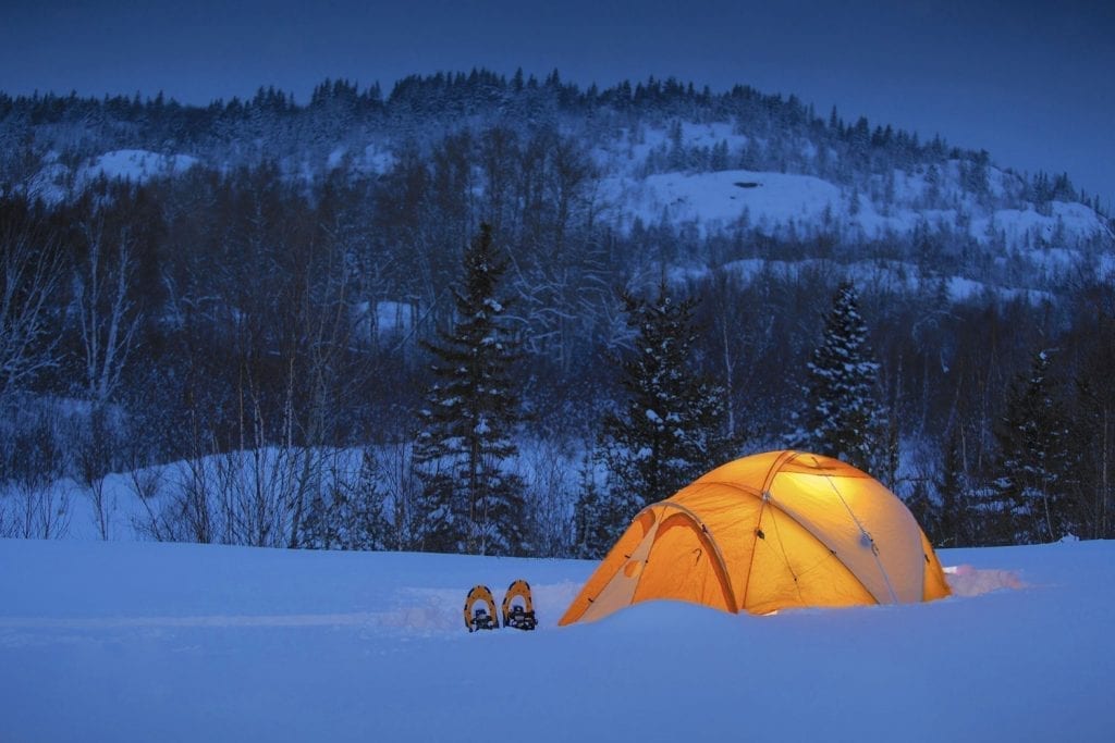 Tent with snowshoes embedded in the snowy landscape