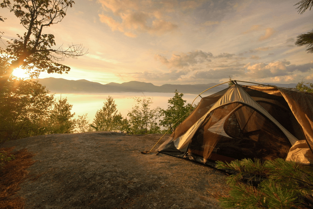 single tent overlooking a scenic lake