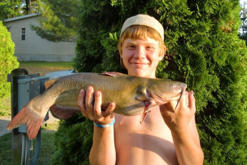 Young Man holding a large Fish